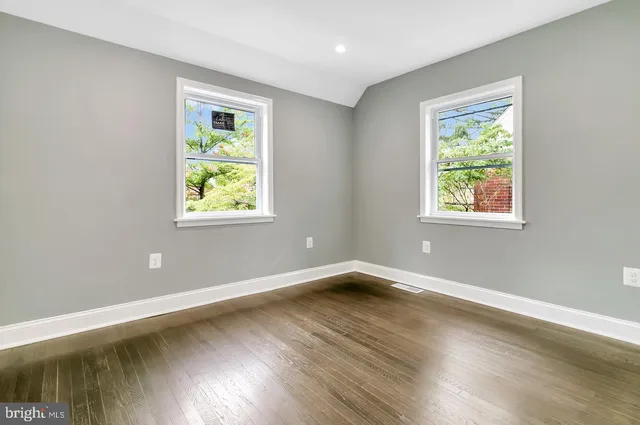 a view of a room with wooden floor and window
