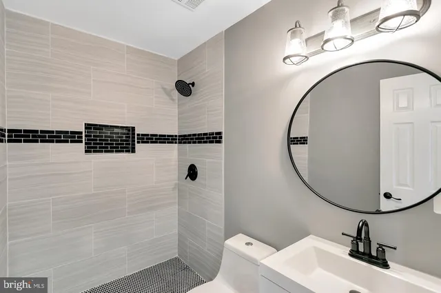 a bathroom with a sink and mirror