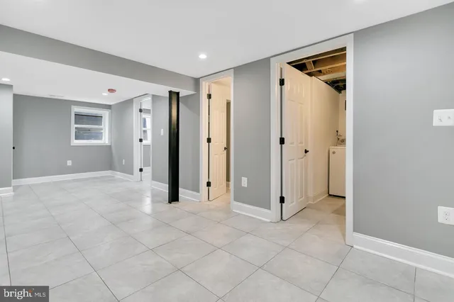 a kitchen with white cabinets a sink and a window