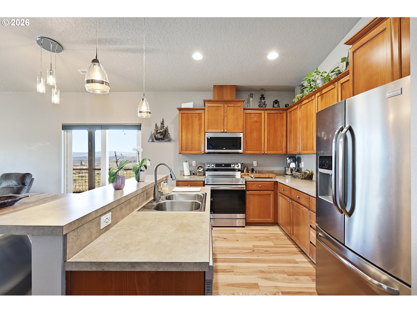 206 Old Mountain Road Goldendale, WA 98620 - Photo 12 of 46 a kitchen with stainless steel appliances granite countertop a refrigerator a sink dishwasher a stove and oven with wooden floor