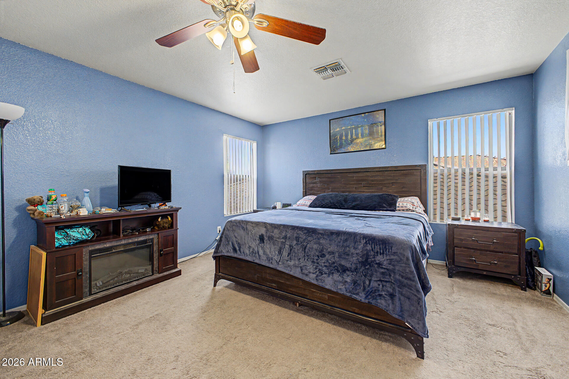 2607 West Bloch Road Phoenix, AZ 85041 - Photo 18 of 34 a bedroom with a bed and a television on the dresser
