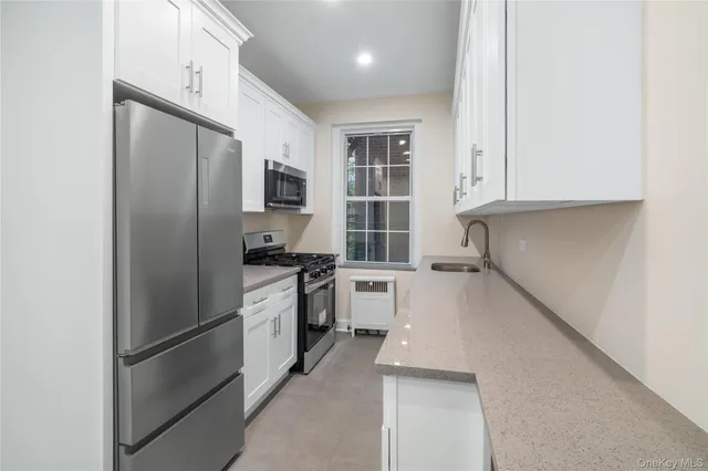 a kitchen with a refrigerator and a sink