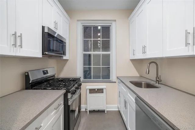 a kitchen that has a sink and a stove