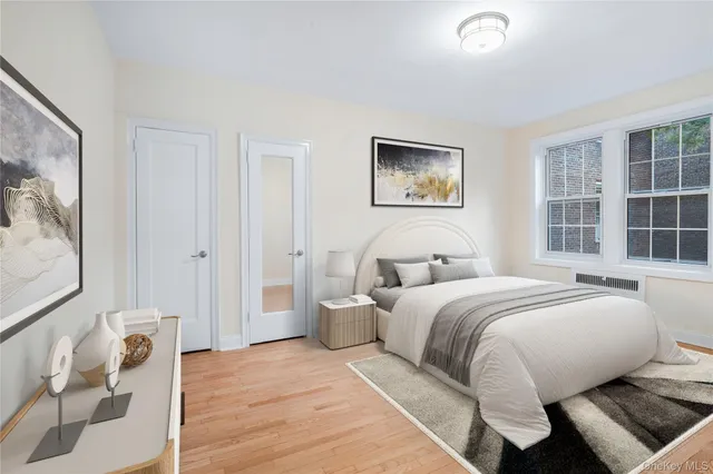 a spacious bedroom with a bed and a window