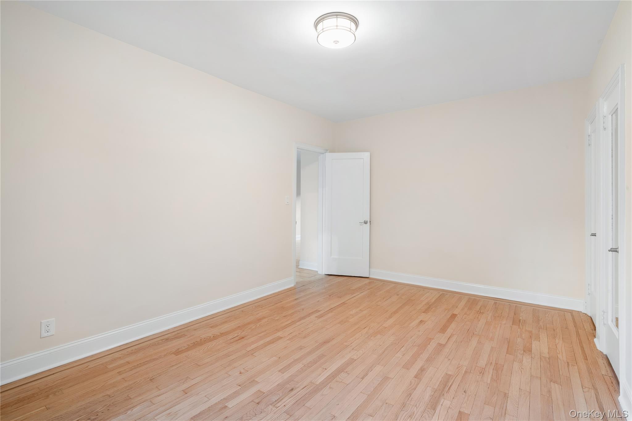 110-07 73rd Road, Unit 3K Queens, NY 11375 - Photo 17 of 21 a view of an empty room with wooden floor