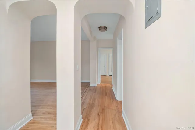a view of a hallway with wooden floor