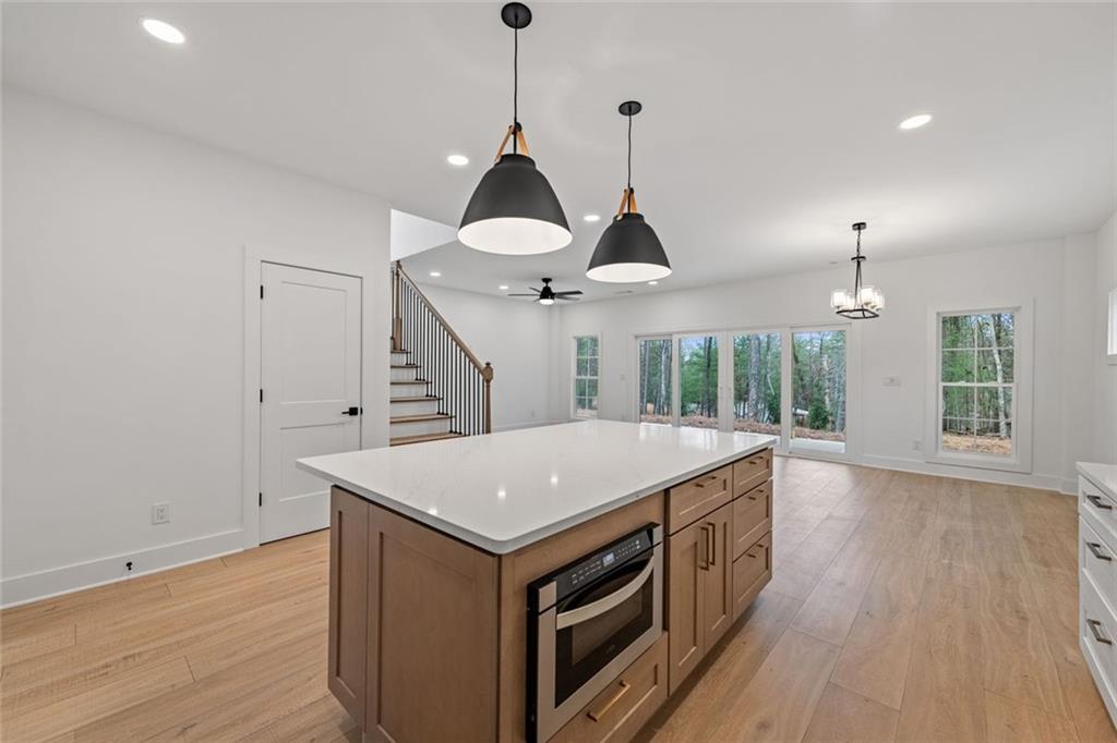 56 Running Brooke Court Morganton, GA 30560 - Photo 12 of 46 a view of a kitchen island with wooden floor and a ceiling fan