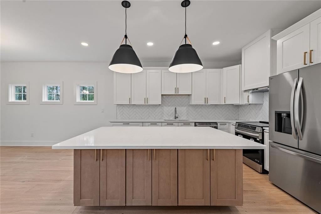 56 Running Brooke Court Morganton, GA 30560 - Photo 15 of 46 a kitchen with kitchen island a stove a refrigerator and cabinets