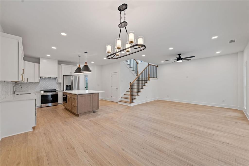 56 Running Brooke Court Morganton, GA 30560 - Photo 20 of 46 a view of a room with wooden floor stairs and a chandelier
