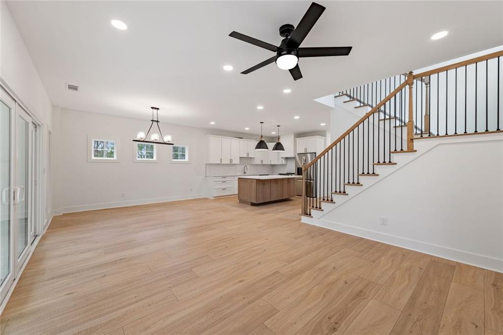 56 Running Brooke Court Morganton, GA 30560 - Photo 21 of 46 an empty room with wooden floor windows and a ceiling fan