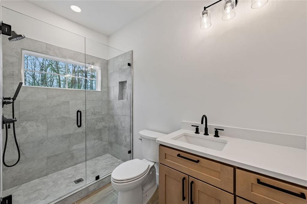 56 Running Brooke Court Morganton, GA 30560 - Photo 26 of 46 a bathroom with a sink a toilet and shower