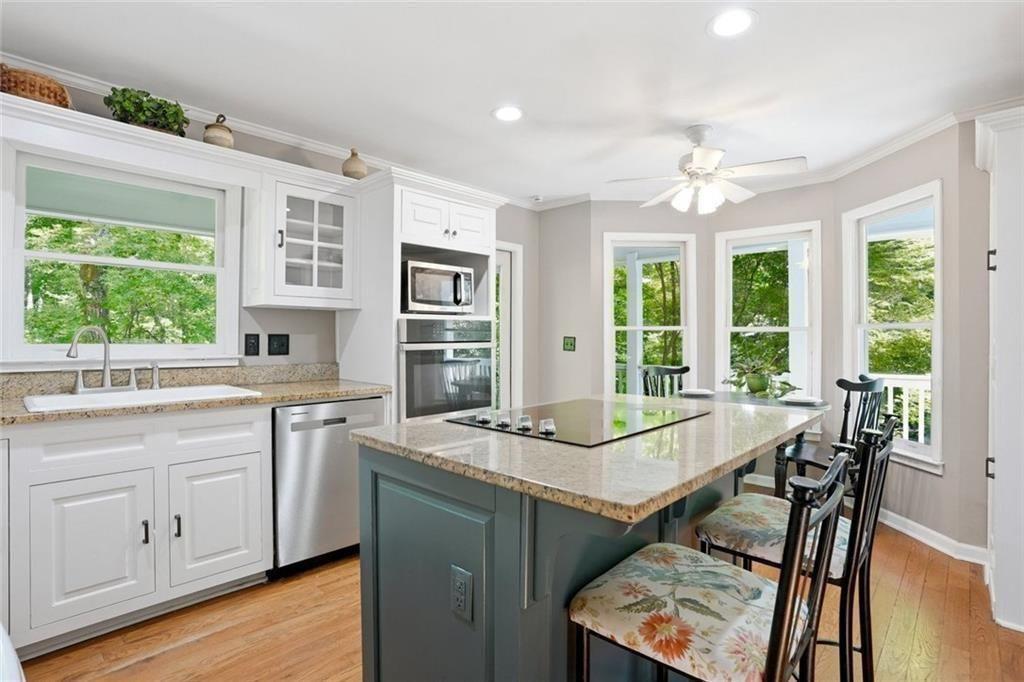 3259 Etchison Road Loganville, GA 30052 - Photo 13 of 50 a view of a kitchen area with furniture window and wooden floor