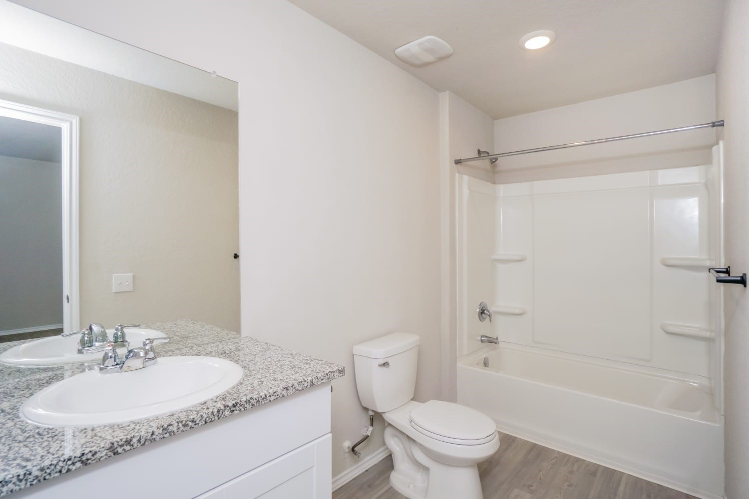 703 Vermilion San Antonio, TX 78221 - Photo 13 of 15 a bathroom with a granite countertop sink toilet mirror vanity and bathtub