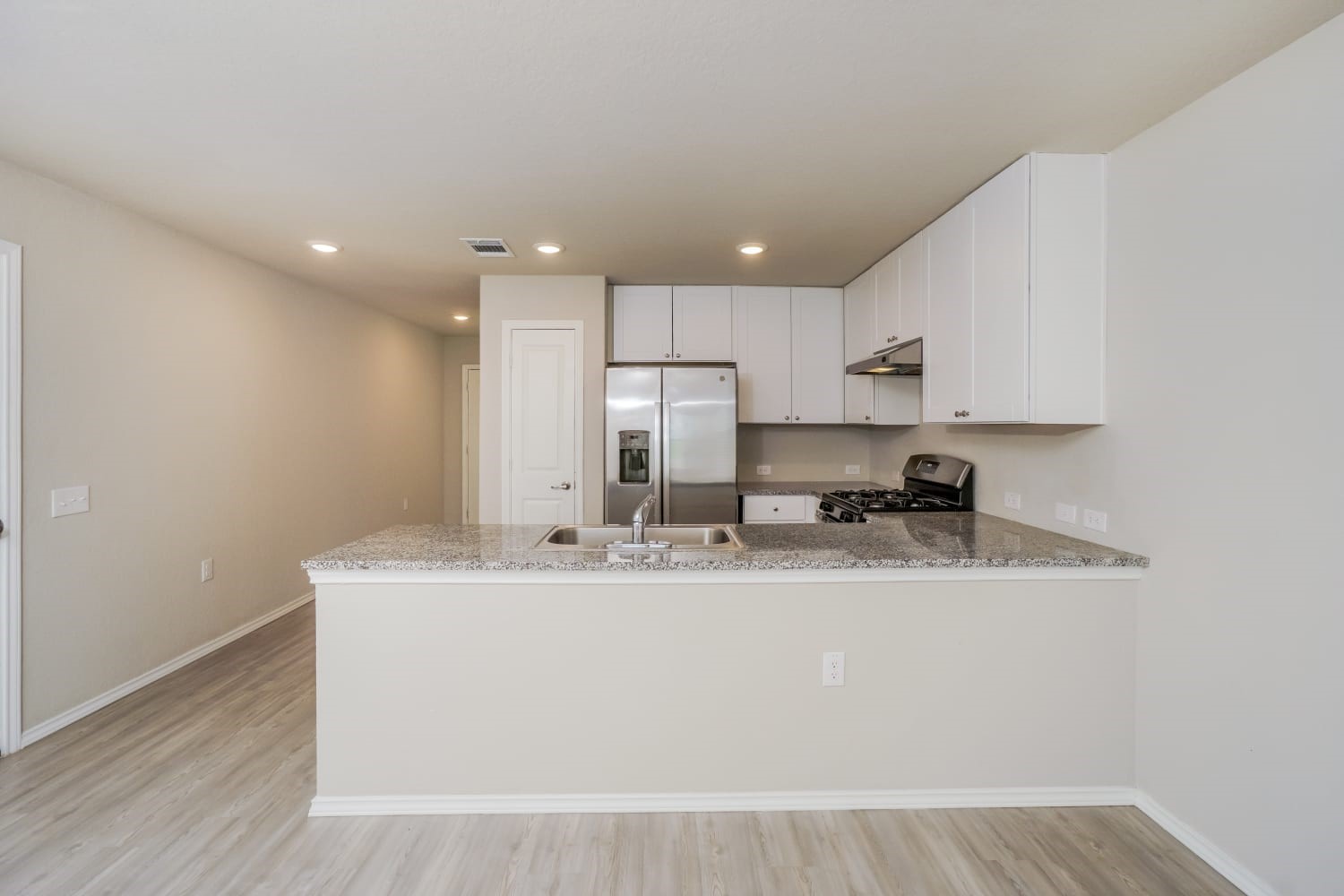 703 Vermilion San Antonio, TX 78221 - Photo 6 of 15 a kitchen with kitchen island stainless steel appliances a sink a stove a microwave a refrigerator and cabinets