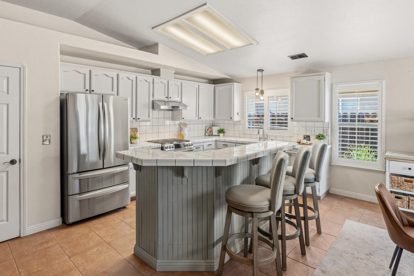 750 Ruger Court Hollister, CA 95023 - Photo 5 of 15 a kitchen with stainless steel appliances granite countertop a dining table chairs refrigerator and sink