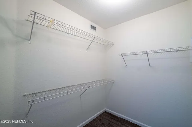 a bathroom with a granite countertop sink toilet and a mirror