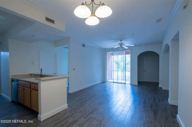 a view of a kitchen with a stove wooden floor