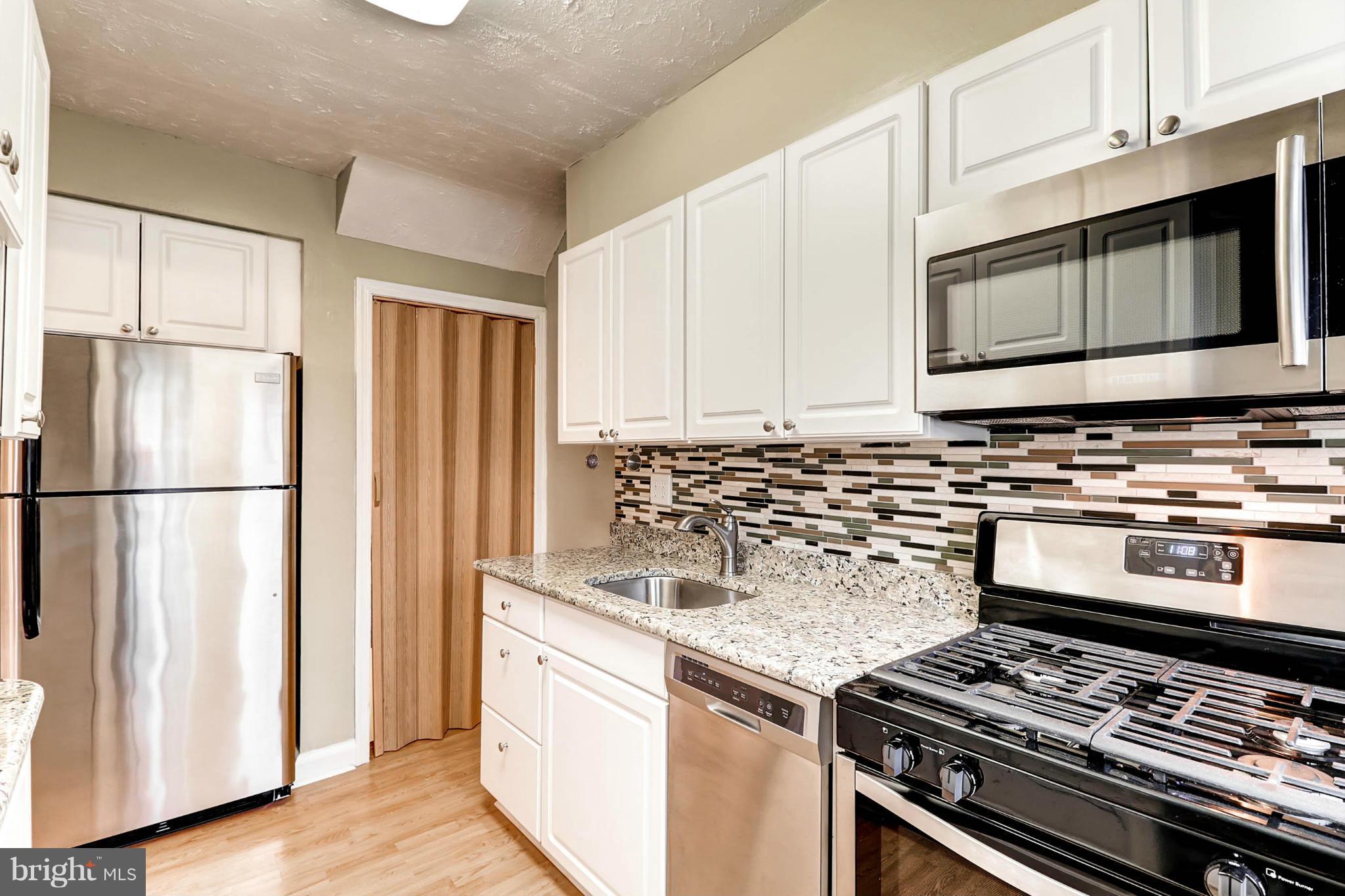 a kitchen with a stove and a microwave