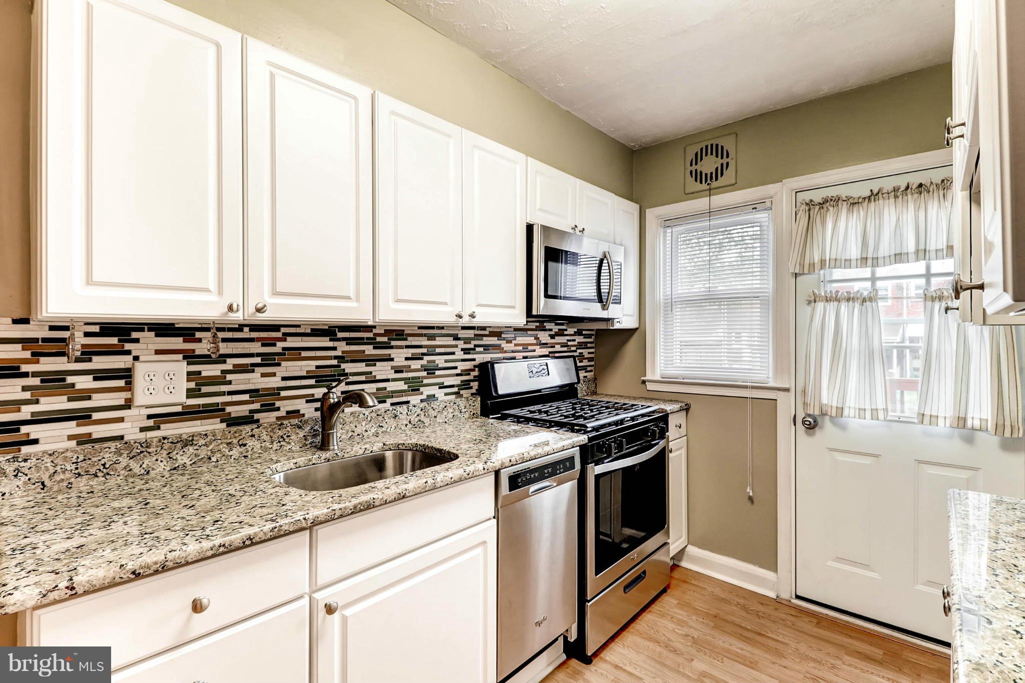 2102 Redthorn Road Baltimore, MD 21220 - Photo 2 of 30 a kitchen with stainless steel appliances a stove a sink and a microwave