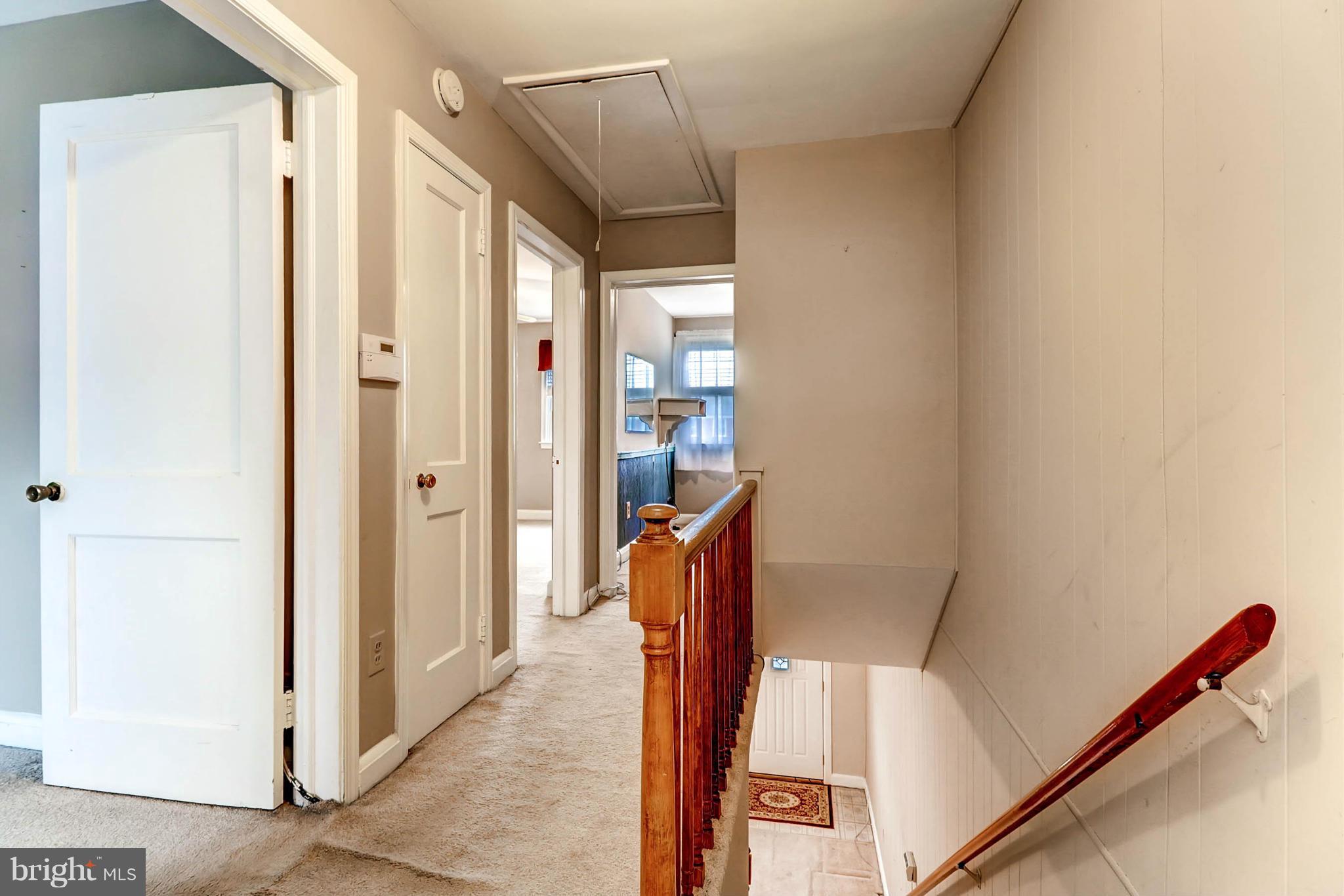 2102 Redthorn Road Baltimore, MD 21220 - Photo 19 of 30 a hallway with wooden floor and stairs