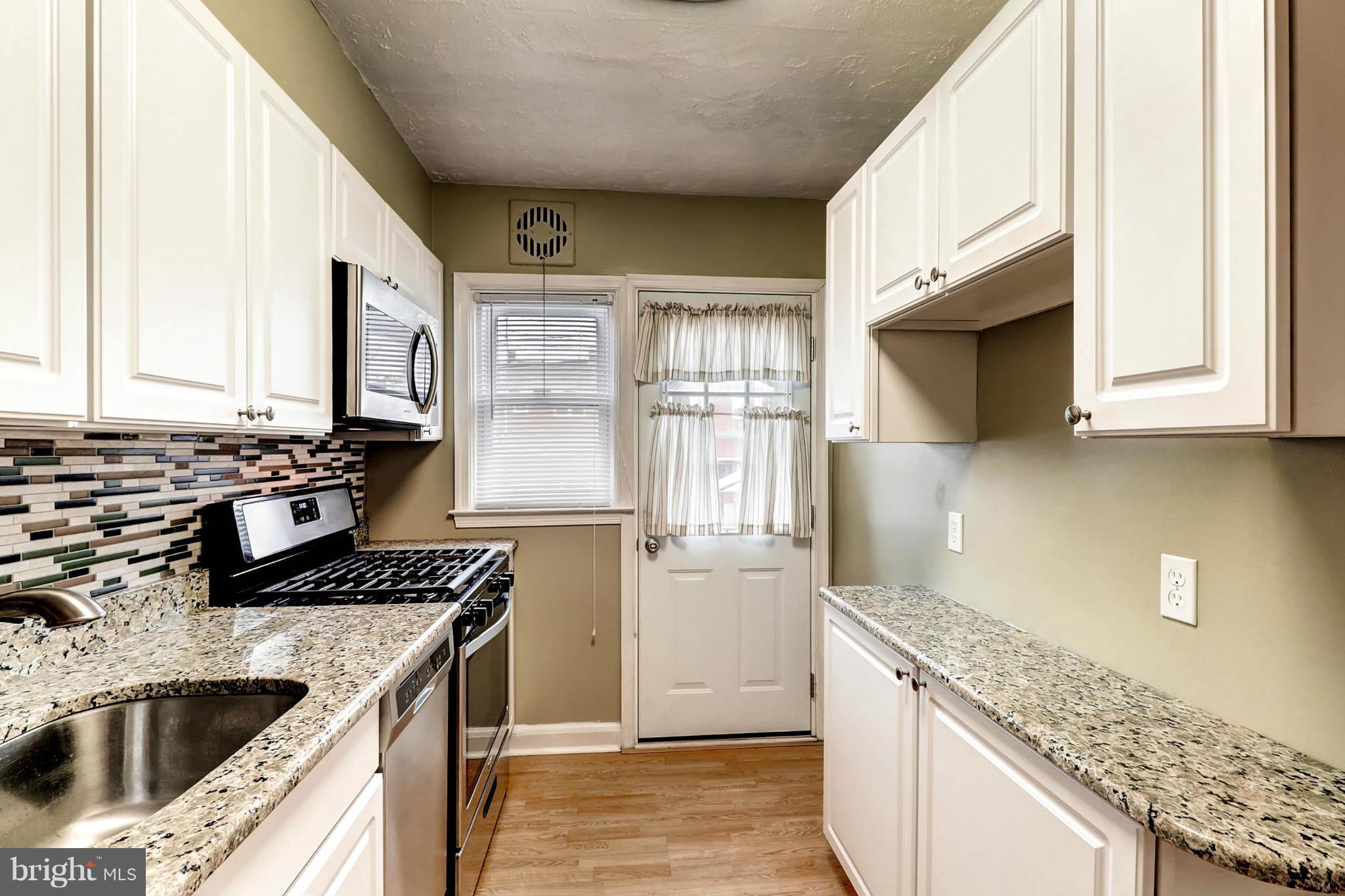 2102 Redthorn Road Baltimore, MD 21220 - Photo 5 of 30 a kitchen that has a sink and a stove