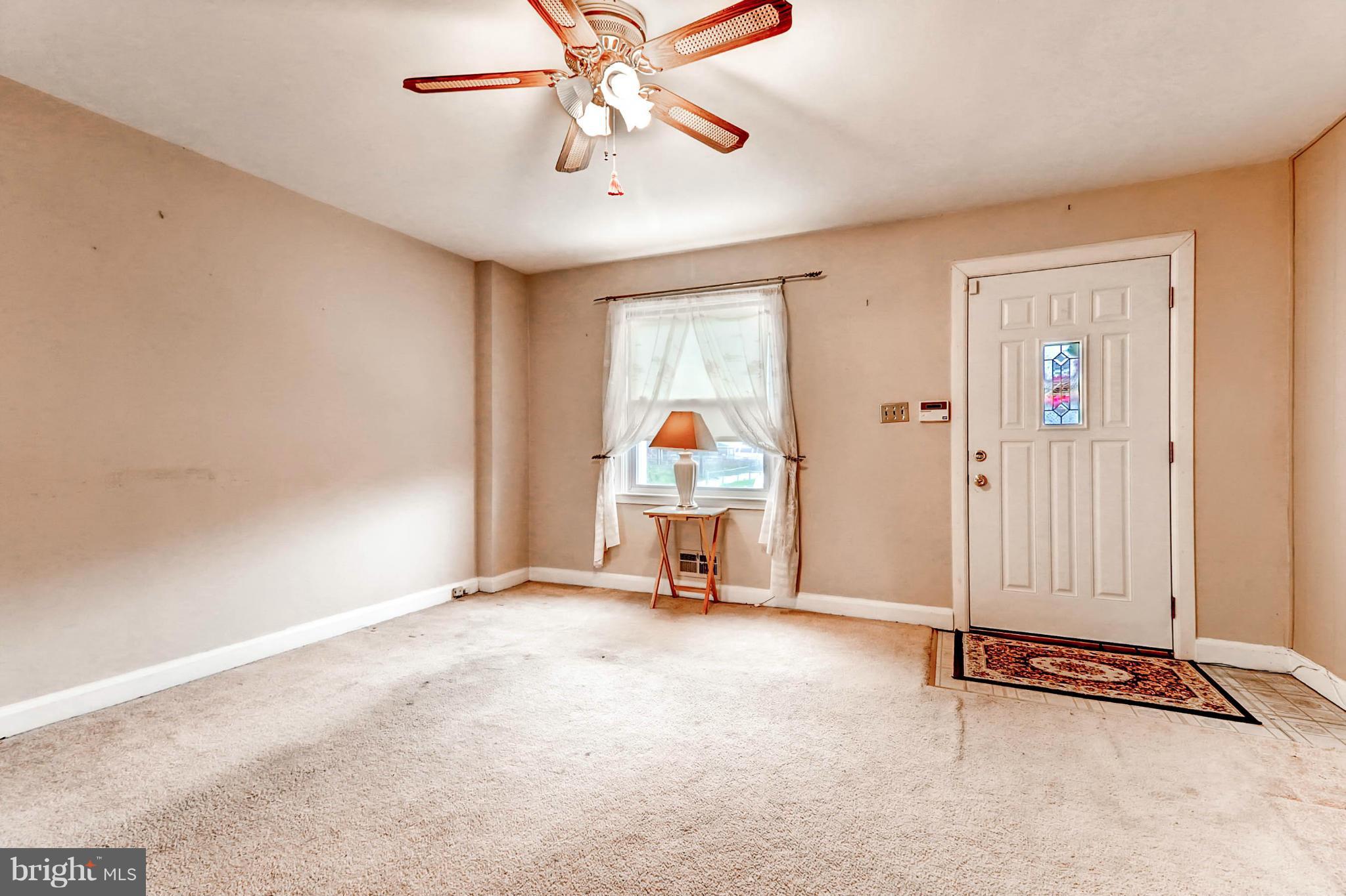 2102 Redthorn Road Baltimore, MD 21220 - Photo 10 of 30 an empty room with chandelier fan and windows