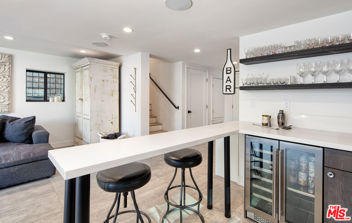5317 Pacific Avenue Marina del Rey, CA 90292 - Photo 12 of 41 a kitchen with stainless steel appliances granite countertop a table chairs in it and wooden floor