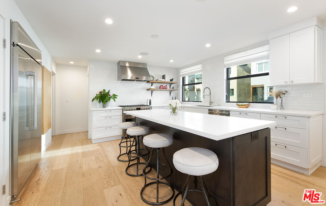 5317 Pacific Avenue Marina del Rey, CA 90292 - Photo 18 of 41 a kitchen with stainless steel appliances kitchen island granite countertop a sink and cabinets