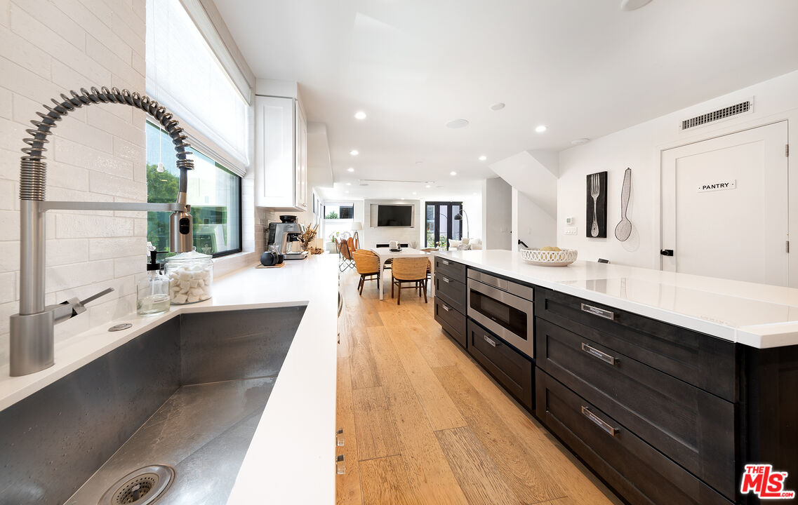 5317 Pacific Avenue Marina del Rey, CA 90292 - Photo 19 of 41 a large kitchen with kitchen island a large counter top space a sink stainless steel appliances and cabinets