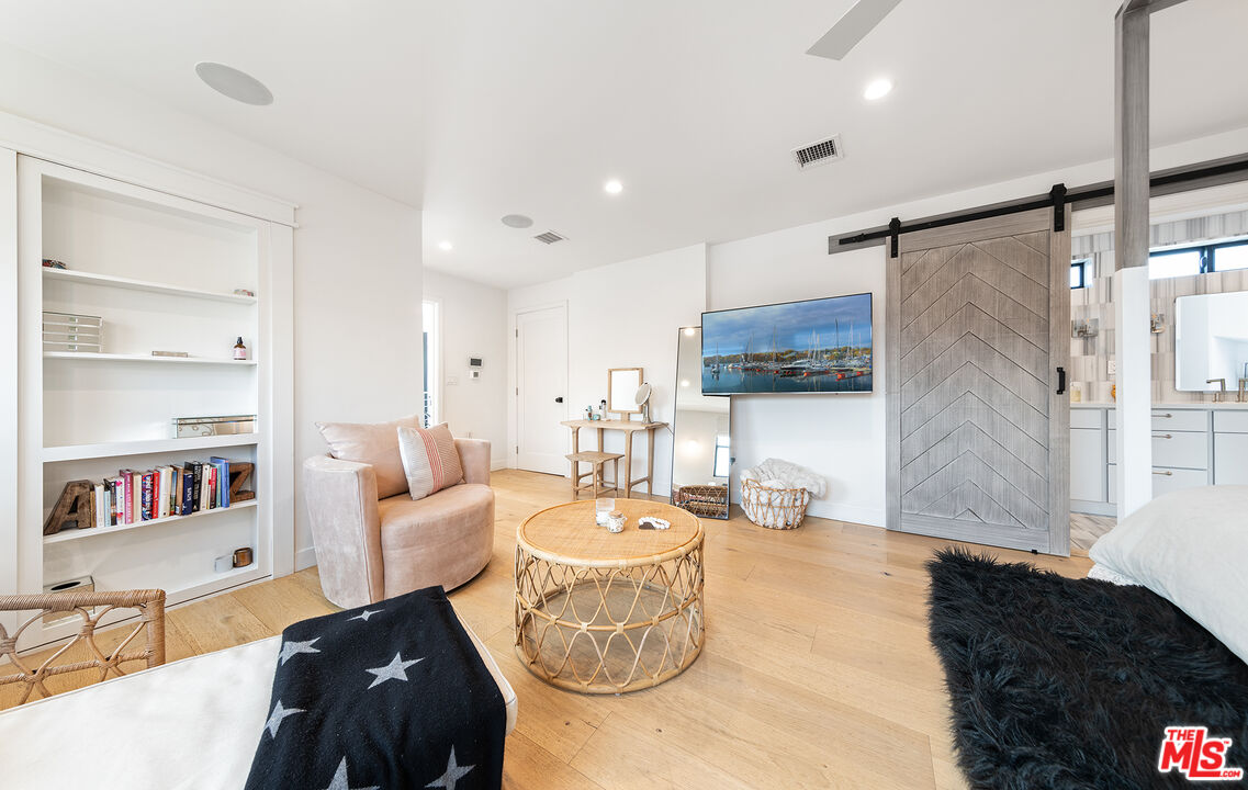 5317 Pacific Avenue Marina del Rey, CA 90292 - Photo 28 of 41 a living room with furniture and a book shelf