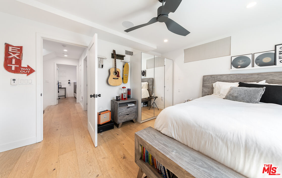 5317 Pacific Avenue Marina del Rey, CA 90292 - Photo 30 of 41 a bedroom with a bed and a chandelier