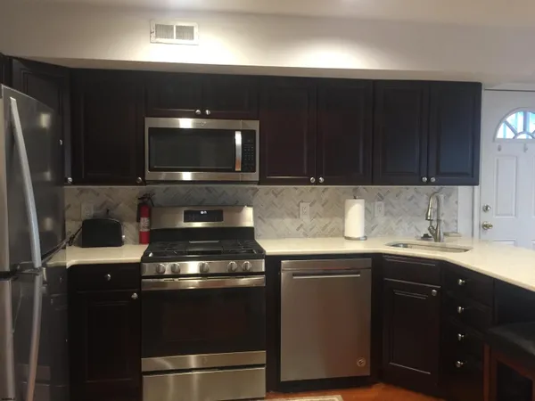 a kitchen with a sink and a stove top oven
