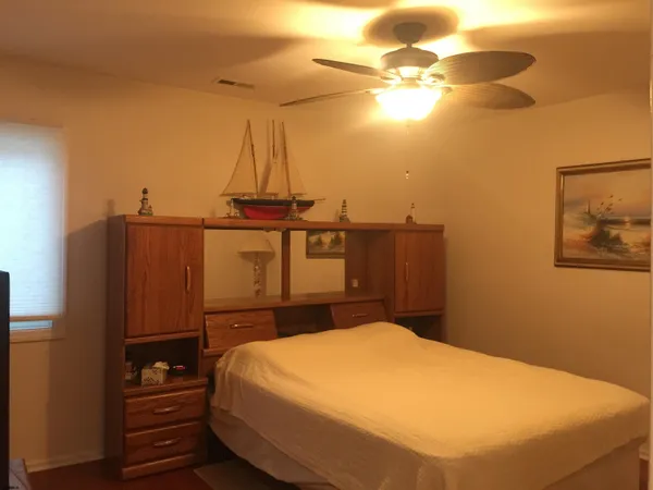 a bedroom with a bed and cabinets