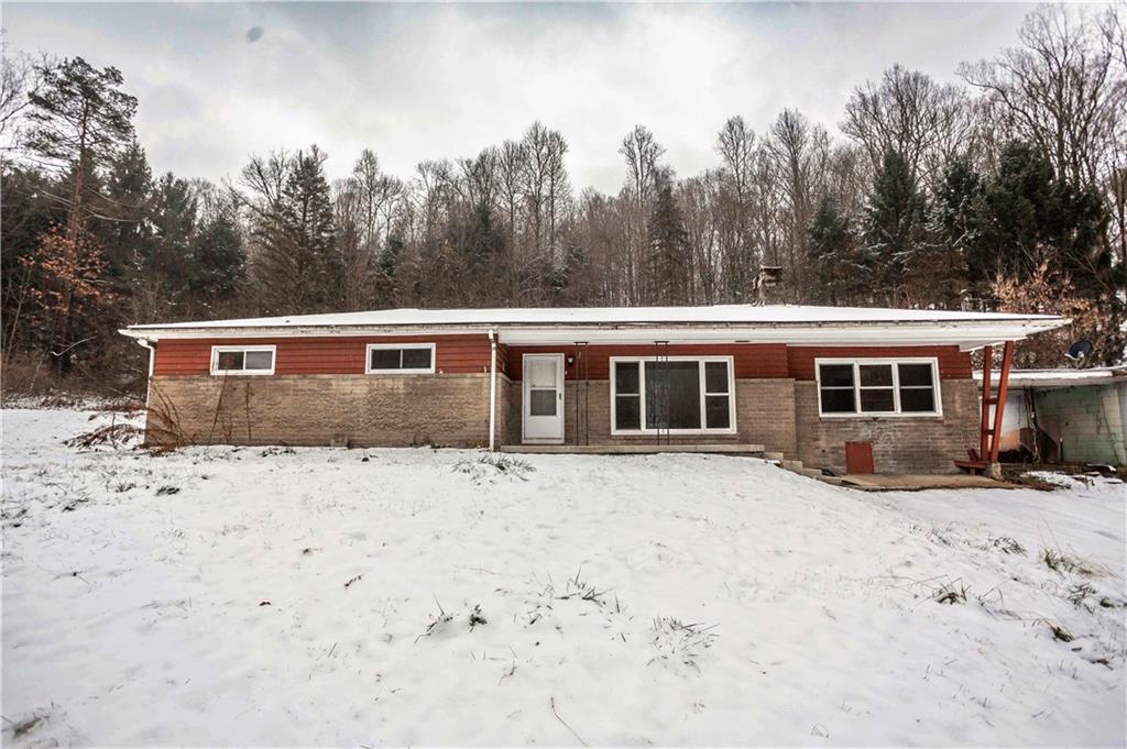 4335 West Pike Road Indiana, PA 15701 - Photo 1 of 37 a front view of a house with a yard covered in snow