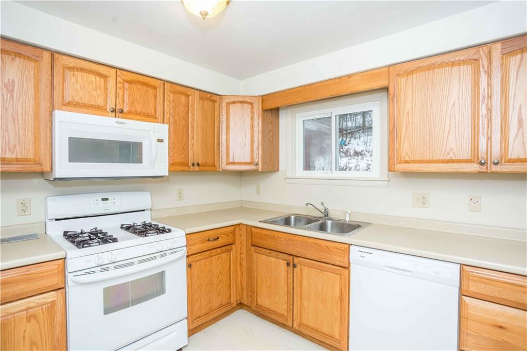 4335 West Pike Road Indiana, PA 15701 - Photo 17 of 37 a kitchen with stainless steel appliances granite countertop white cabinets sink and window