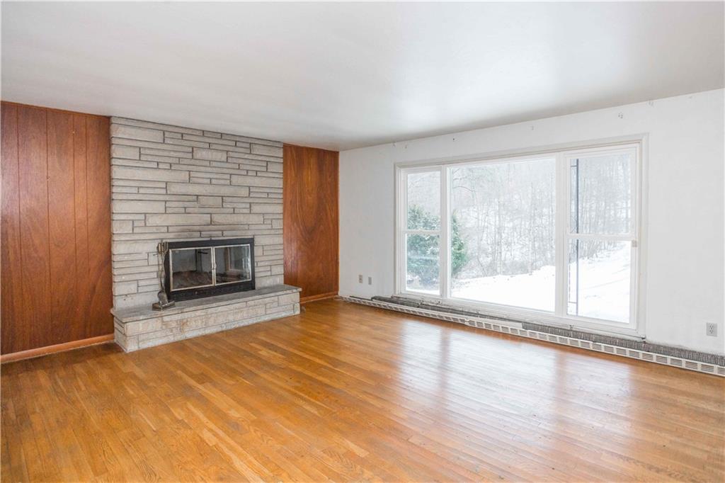 4335 West Pike Road Indiana, PA 15701 - Photo 19 of 37 an empty room with wooden floor fireplace and windows