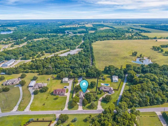an aerial view of a house with a lake view