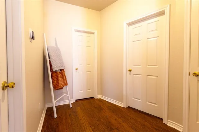 an empty room with wooden floor and a window