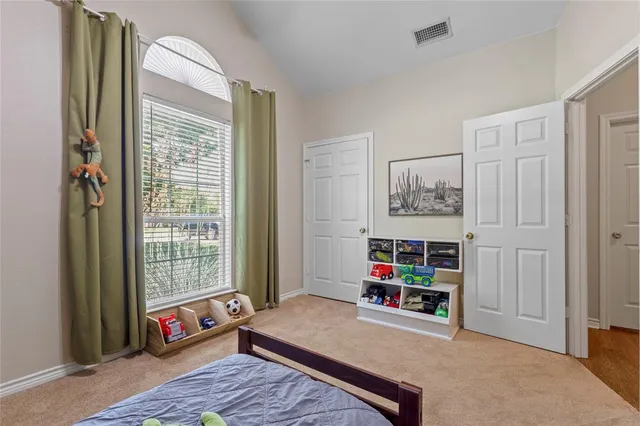 a living room with baby crib furniture and a window