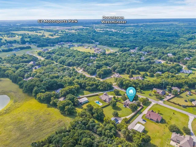 an aerial view of a house with a swimming pool
