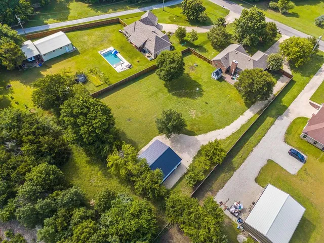 an aerial view of residential houses with outdoor space