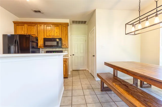a kitchen with stainless steel appliances a refrigerator and a stove top oven
