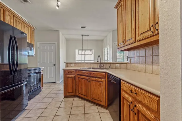a kitchen with stainless steel appliances granite countertop a sink and cabinets
