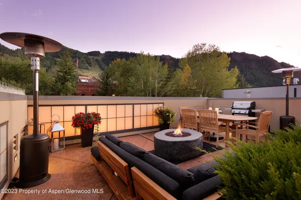 a view of a chairs and table in patio
