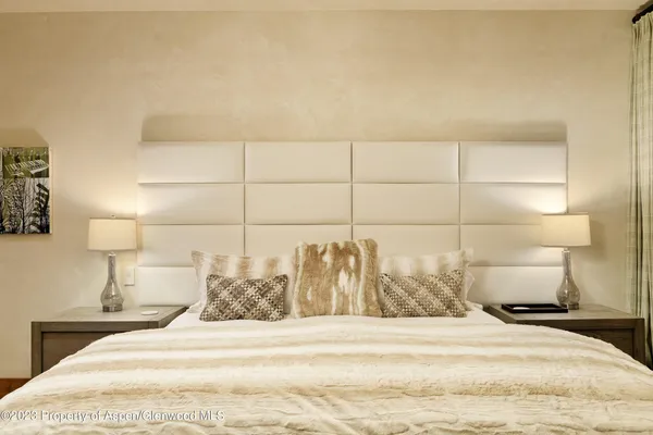 a bedroom with a bed and lamp