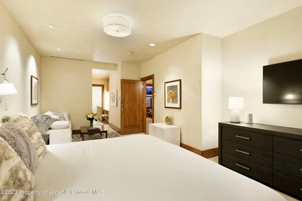 a bedroom with a bed and a flat screen tv