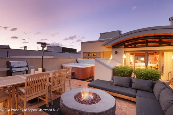 a balcony with furniture and a fireplace
