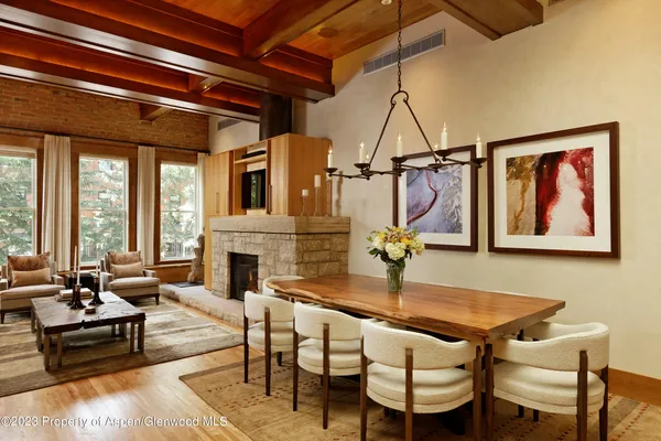 a living room with furniture a fireplace and floor to ceiling window