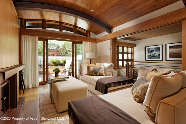 a bedroom with furniture and a large window