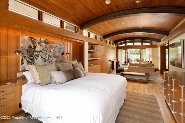 a bedroom with a large bed and a large window